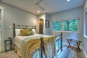 a bedroom with a bed and a window at Creeksong in Ellijay