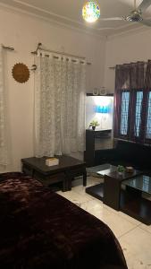 een slaapkamer met een bed en een woonkamer bij Stay with Abhishek in Gwalior