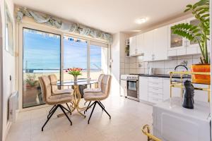 a kitchen with a table and chairs and a window at Great view apartment in Zadar
