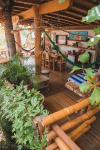 a room with a table and chairs and plants at Frutas y Verduras in Puerto Escondido