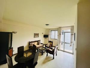 a living room with a couch and a table at Minimal Guest Houses in Addis Ababa