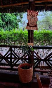 a sign that says love your house and a potted plant at splash resort hotel in Mtwara