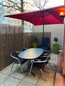 a table and chairs under an umbrella on a patio at Appartement T2 avec Terrasse centre ville d’Aix en Provence in Aix-en-Provence