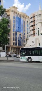 a bus is parked in front of a building at فندق قافلة الحجاز in Mecca