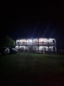 a large white building with lights on it at night at LES VAGUES BLEUES in Ilendé