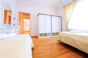 a bedroom with two beds and a large window at Giardino dei Colori 107 - Residence Pool&Fitness in Toscolano Maderno +21 photos