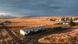 an aerial view of a field with a house at Bories - Boutique Guest House in Puerto Natales