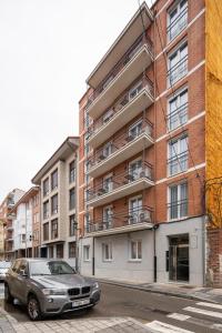 a car parked in front of a brick building at InsideHome Palencia Catedral in Palencia