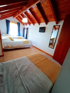 Postel nebo postele na pokoji v ubytování Apart Hotel del Pellin