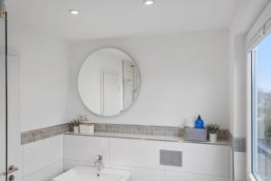 a bathroom with a sink and a mirror at Skyview Retreat Maisonette in Essen