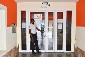 a man standing in front of a door at Kyaala Djadsal Moradias pool&sea in Santa Maria +42 photos