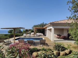 a backyard with a swimming pool and a house at Résidence La Plage in Propriano
