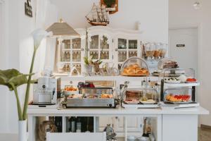 a white kitchen with food on a counter at Hotel Villa Vera 2 in Fažana
