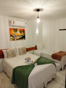 a room with two beds in a room at Japaratinga Suites in Japaratinga +58 photos
