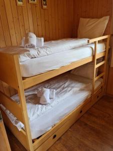 two bunk beds in a wooden room with towels at Charming Apartment Only 150 Meters from the Ski Lift in Münster