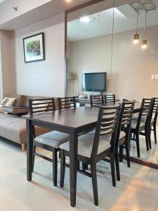 a dining room with a table and chairs and a couch at The Beacon Condo (1BR Unit) in Manila +30 photos