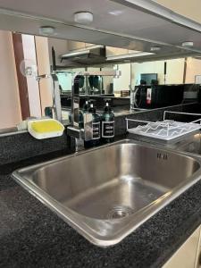 a kitchen with a stainless steel sink in a kitchen at The Beacon Condo (1BR Unit) in Manila