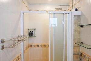 a shower with a glass door in a bathroom at Makati Altean Apartment (Leonora Room) in Manila +26 photos