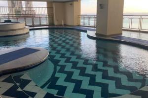 a swimming pool on the top of a building at Alpha Grandview Malate Condo 2005 in Manila