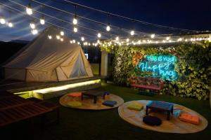 a tent with lights and a sign that says this is your happy hug at Maria Deck Urban Glamping in Manila