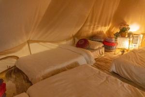 a bedroom with three beds in a room at Maria Deck Urban Glamping in Manila