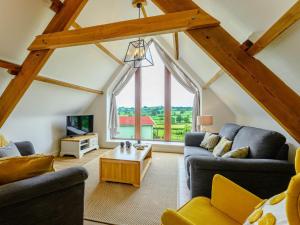 a living room with two couches and a table at 3 Bed in Brecon 88249 in Brecon