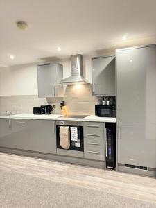 a kitchen with stainless steel appliances at Flat 501 Chic Apartment Living in Yeadon