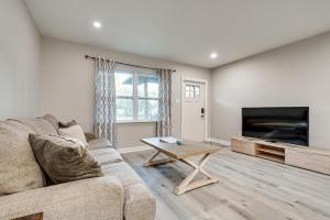 a living room with a couch and a flat screen tv at Idyllic Oldsmar Vacation Rental 1 Mi to Beach! in Oldsmar