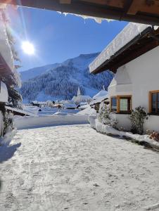a snow covered yard in front of a house at Sonnenbichl in Berwang