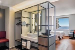 a bathroom with a sink and a mirror at Fiesta Inn Mazatlán in Mazatlán