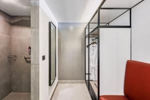 a bathroom with a walk in shower and a glass shower stall at Fiesta Inn Mazatlán in Mazatlán