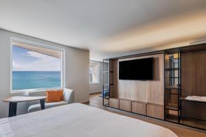 a hotel room with a bed and a large window at Fiesta Inn Mazatlán in Mazatlán +20 photos