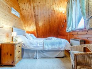 a bedroom with a bed in a wooden room at 2 bed in Launceston TWIME in Saint Clether