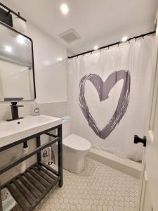 Baño con un corazón en la cortina de la ducha en Cozy, Large and Fully Furnished - Near the L Train en Brooklyn