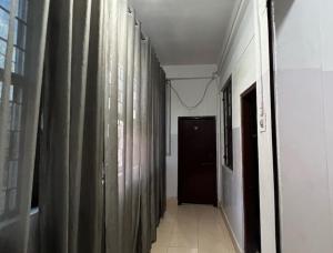 a hallway with curtains and a door in a room at SPOT ON Hotel Mist in Dimāpur