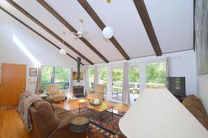 a living room with couches and a ceiling at Serendipity -- Hot Tub - Pet Friendly - Fire Pit - Grill - Porch - Deck - Wifi - Pool Access - Games in Berkeley Springs