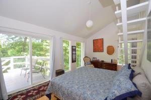 a bedroom with a bed and a balcony at Serendipity -- Hot Tub - Pet Friendly - Fire Pit - Grill - Porch - Deck - Wifi - Pool Access - Games in Berkeley Springs +58 photos