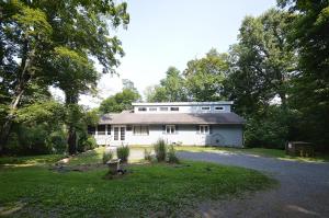 a white house with a driveway in front of it at Serendipity -- Hot Tub - Pet Friendly - Fire Pit - Grill - Porch - Deck - Wifi - Pool Access - Games in Berkeley Springs