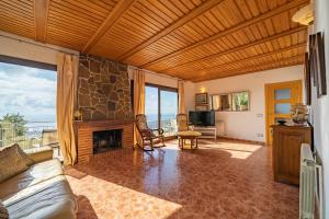 a living room with a fireplace and a couch at HomeHolidaysRentals Malvina in Pineda de Mar