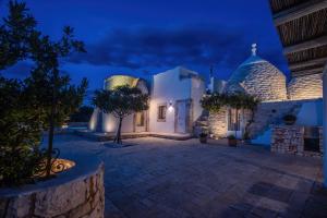 a courtyard of a house at night at TrullOlive in Ostuni