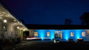 a building with blue lights on it at night at Loughcrew Courtyard House in Oldcastle