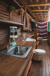 a kitchen with a sink and a toilet at Frutas y Verduras in Puerto Escondido