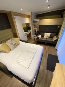 a bedroom with a large bed and a living room at Neptunes Pod in Fort William