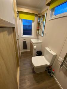a small bathroom with a toilet and a window at Neptunes Pod in Fort William