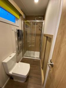 a small bathroom with a shower and a toilet at Neptunes Pod in Fort William