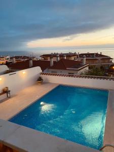 a swimming pool on the roof of a house at Private pool Sunset Terrace Apartment in Ericeira