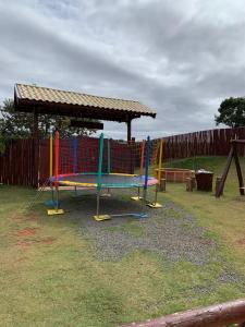 a playground with colorful swings and a gazebo at Chácara Recanto Quero-Quero in Tatuí +25 photos