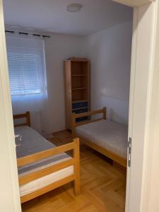 mały pokój z 2 łóżkami i oknem w obiekcie Ilić dvosoban apartman w mieście Ub
