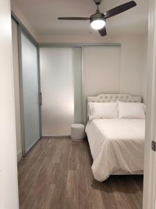 a bedroom with a bed and a ceiling fan at Cozy Studio Sunset FREE parking and WIFI in Los Angeles