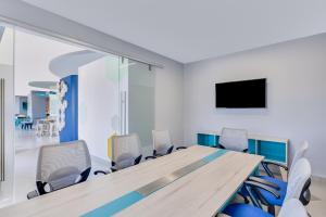 a conference room with a long table and chairs at One Mazatlán in Mazatlán